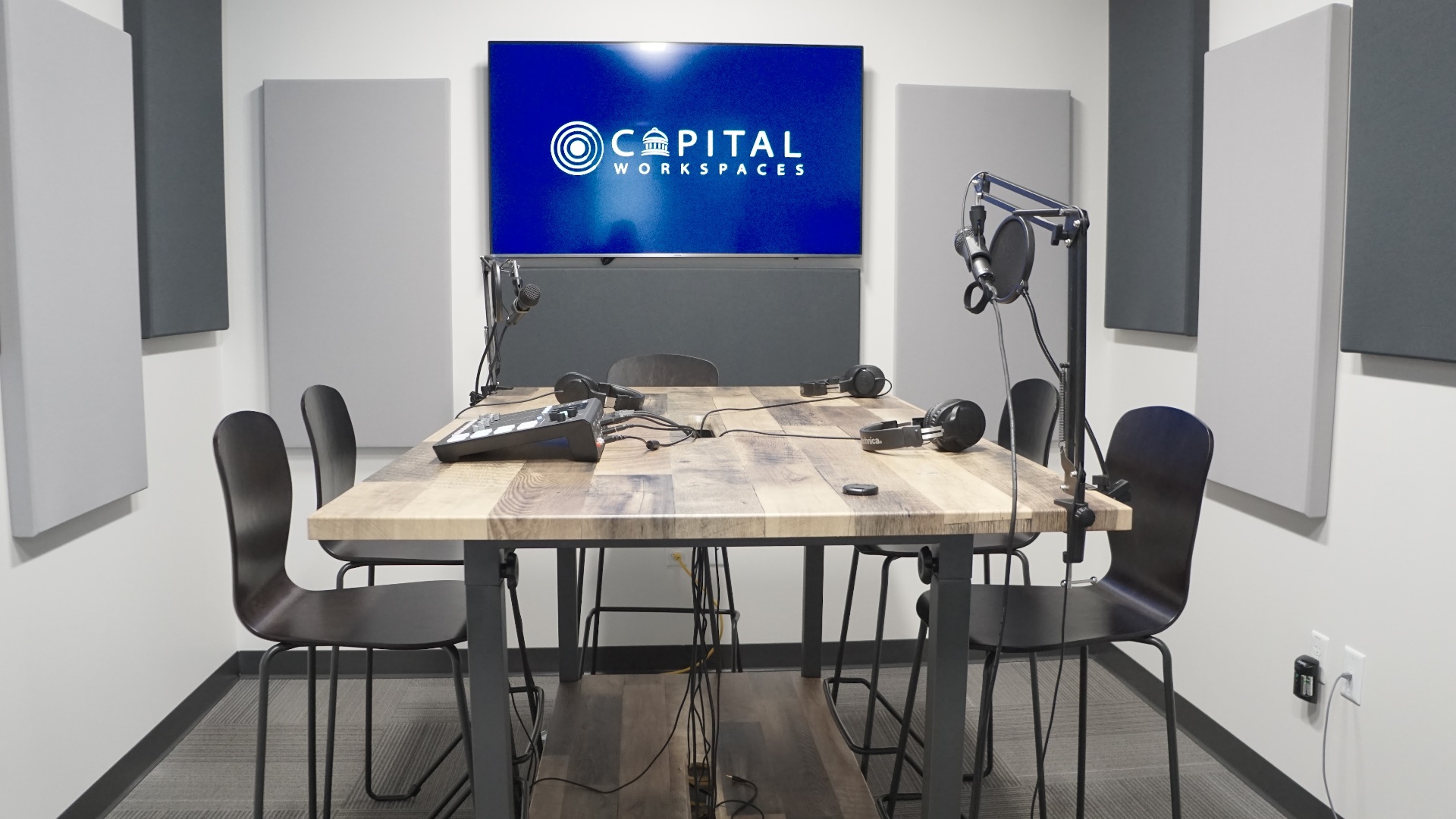 Podcast studio with microphones and acoustic panels