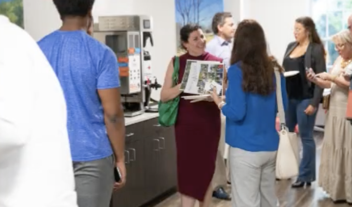 Members chatting in the kitchen and common area